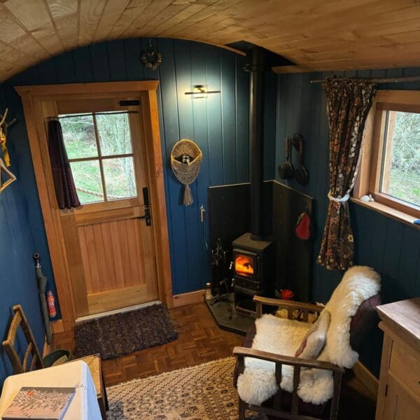 Fiddler's Green Birkenshaw Shepherd's Hut, interior view with wood burner
