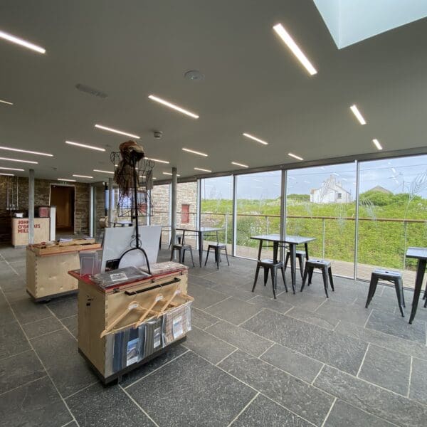 A view of the foyer with tables, the gift shop an the outdoor seating