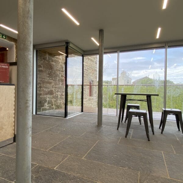 Inside the mill foyerwith a view out of the large glass walls over the hills.