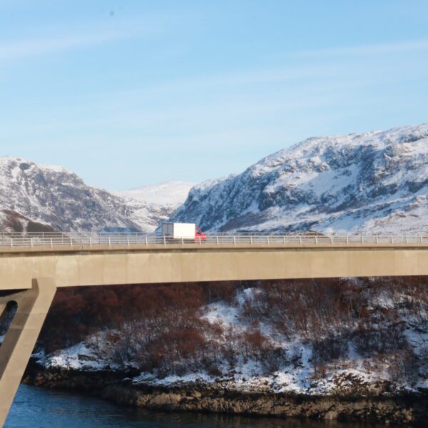 Kylesku Bridge on a wintery day viewed from a distance with a lorry travelling across
