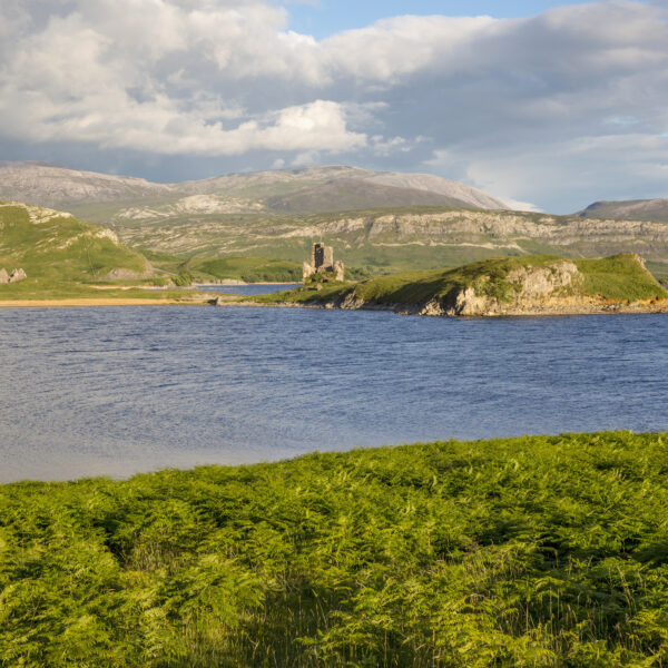 Loch Assynt viewed from up high with Ardvreck Castle in the far distance