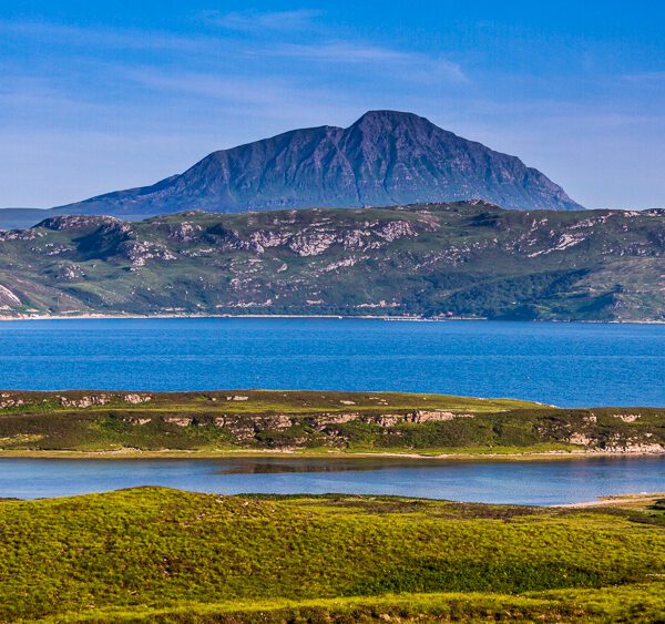 A view over Loch Eriboll with blue waters and ben Hope in the background