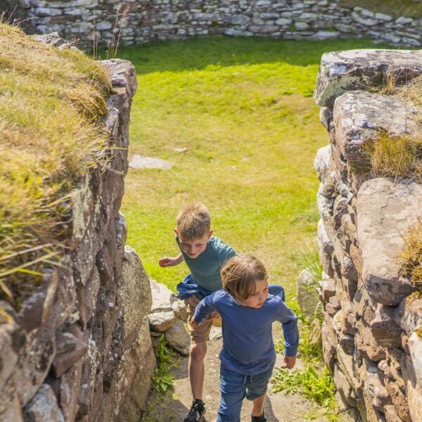 two boys exploring inside the broch