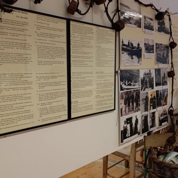 A museum display showing the history of fishing in caithness, with photos and a board detailing a conversation with a descendant of a fisher, at the Dunbeath Heritage Museum, Caithness