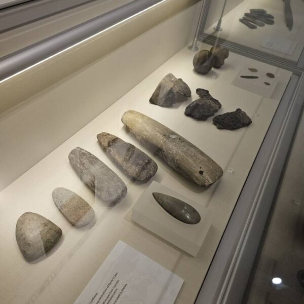 Ancient axes, pottery, knives, and balls found near Dunbeath in a glass display case, at the Dunbeath Heritage Museum, Caitness